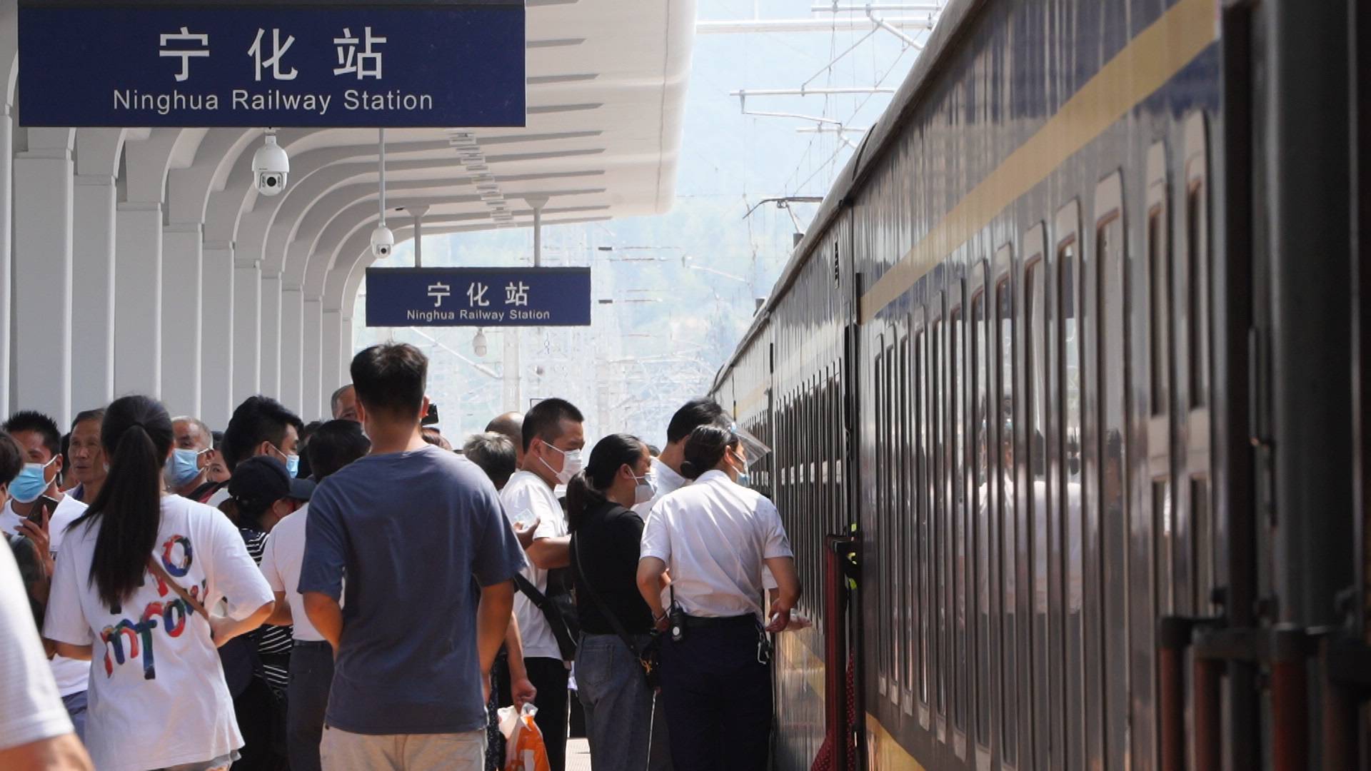 9月30日,在宁化火车站,旅客有序登上列车.