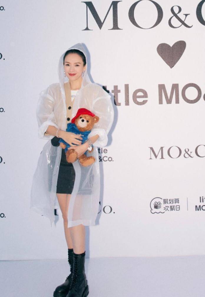 穿透明|章子怡雨中撑伞看秀,穿透明雨衣踩短靴,坐C位抱小熊哪像俩娃妈