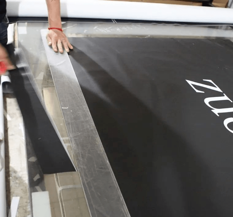 另外,黑白布不同于普通喷绘布,厚度大,韧性好,所以在工人将黑白布绷在