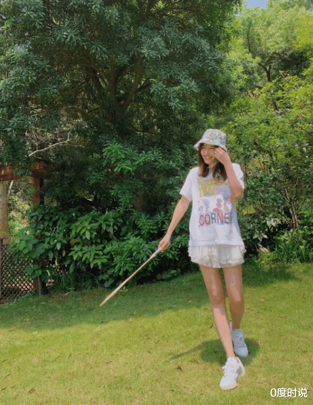 只见张子萱站在回廊上,周边精致看着非常迷人,而她则穿着件纯白色