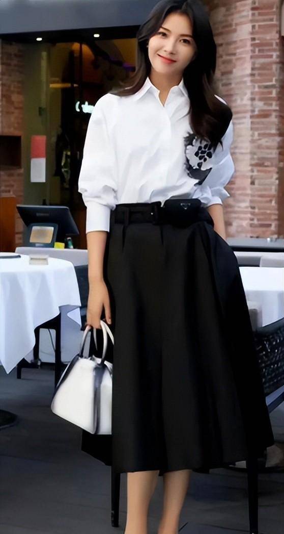 着装tips:白衬衫,黑裙子,银色钱包刘涛的这套穿搭以白色衬衫,黑色裙子