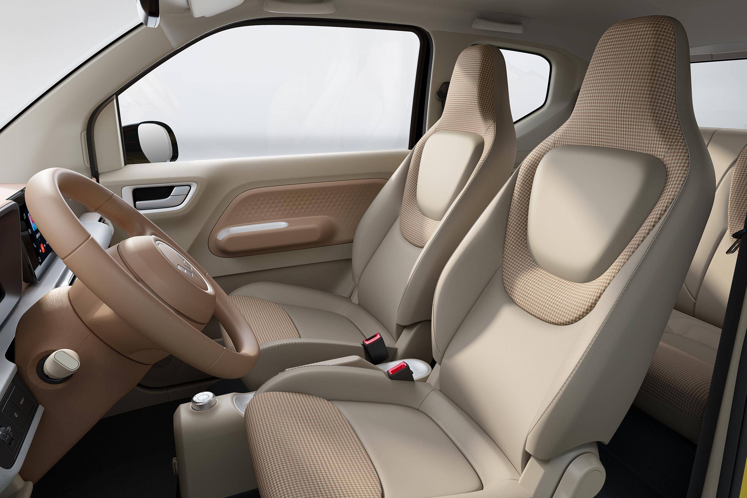 内饰方面,五菱宏光miniev第三代马卡龙采用圆形两辐式多功能方向盘配