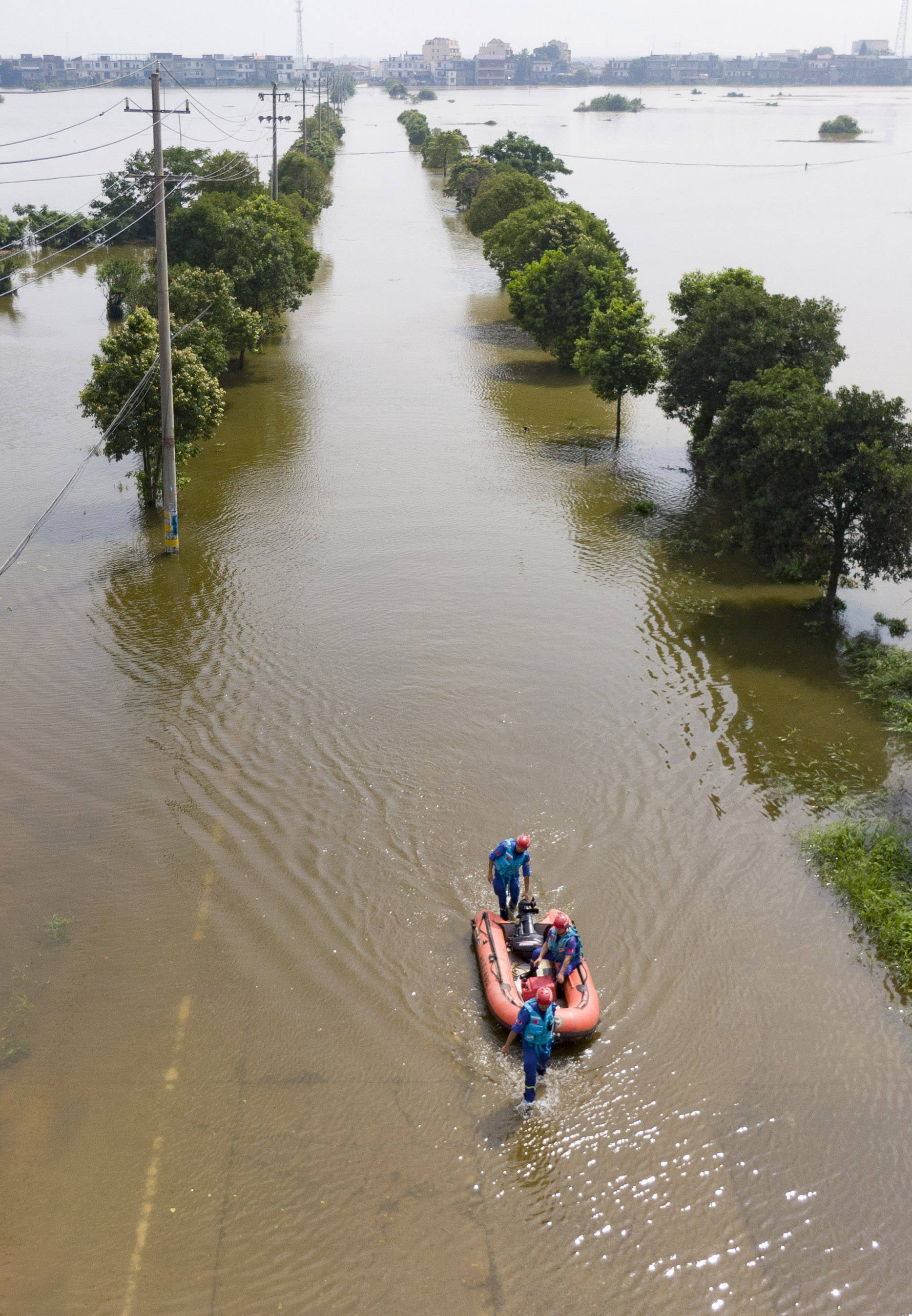 7月13日,在永修县三角乡,救援人员乘坐橡皮艇前往救援(无人机照片)