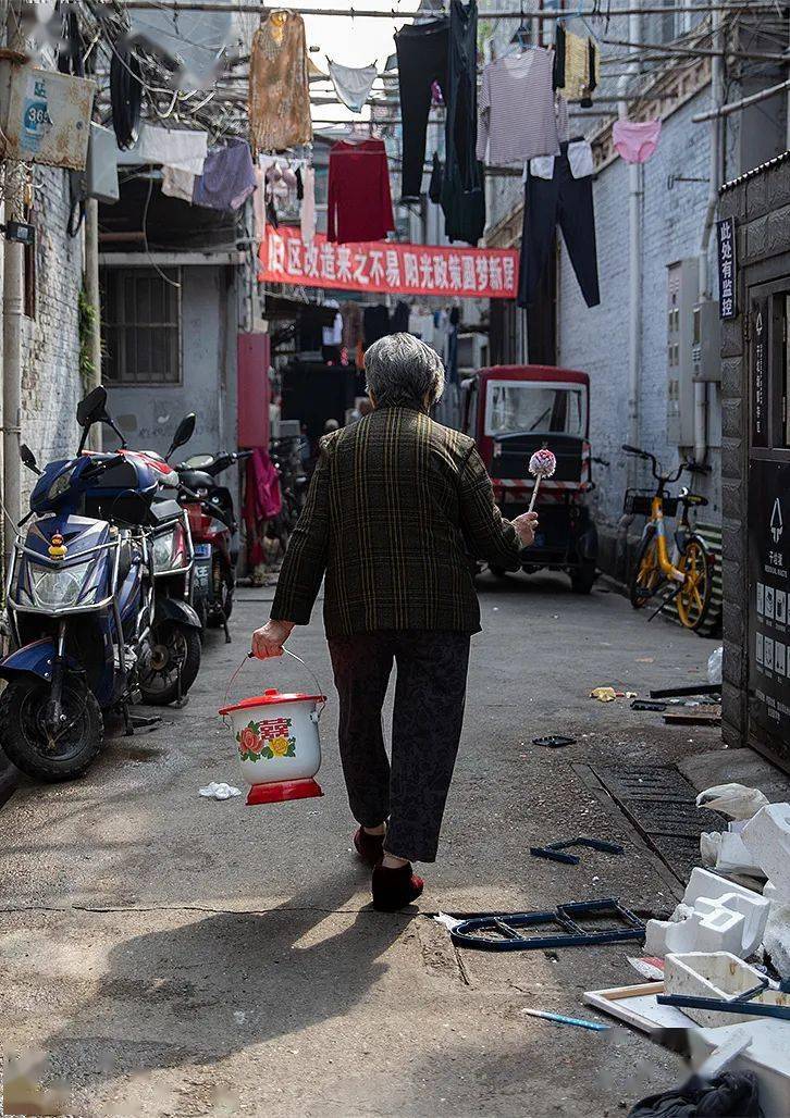 上午的阳光终于越过石库门的房子照进狭小的弄堂,老奶奶洗好痰盂,拿着