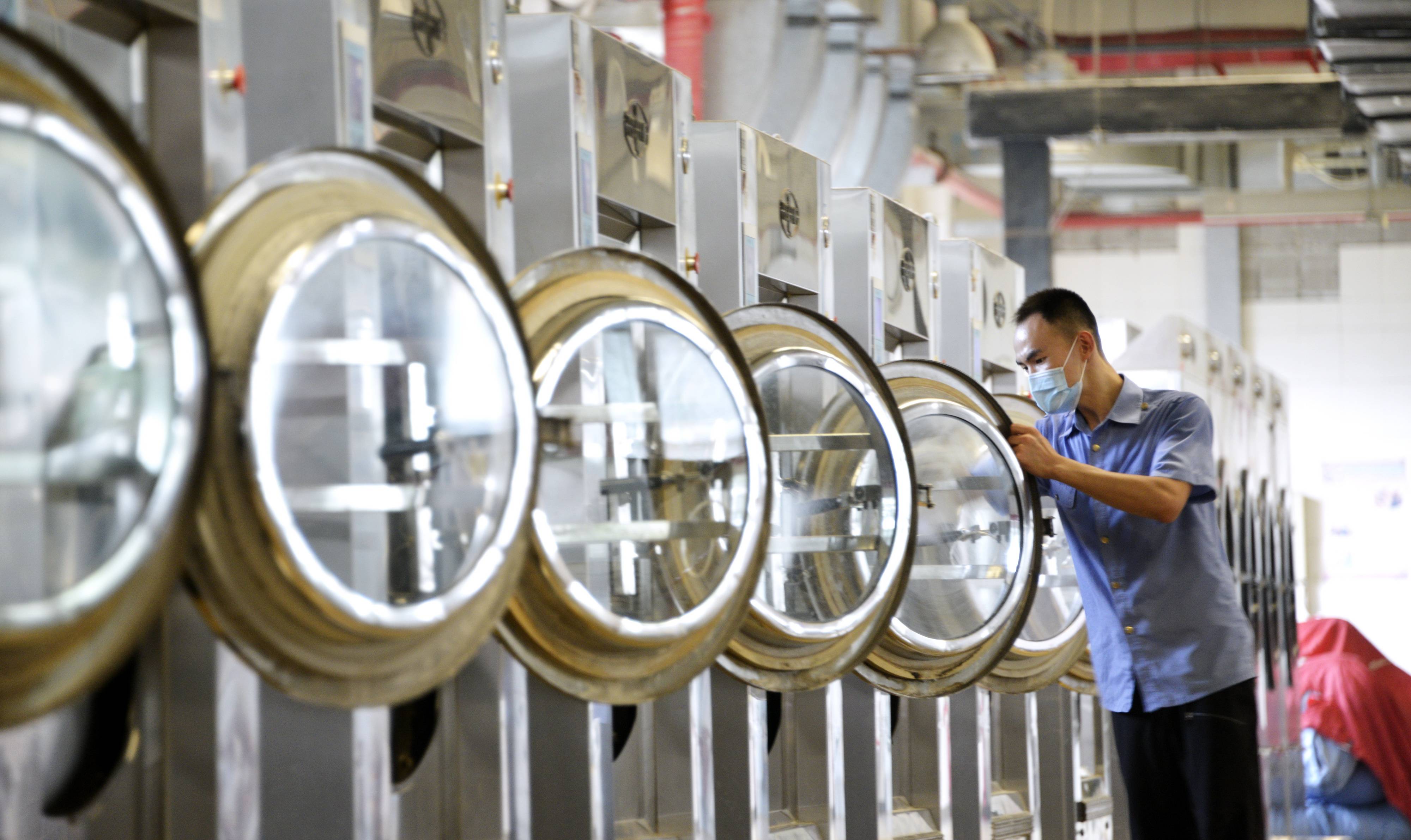 8月23日,北京客运段洗涤车间的工作人员在进行洗涤前设备清洁消毒工作