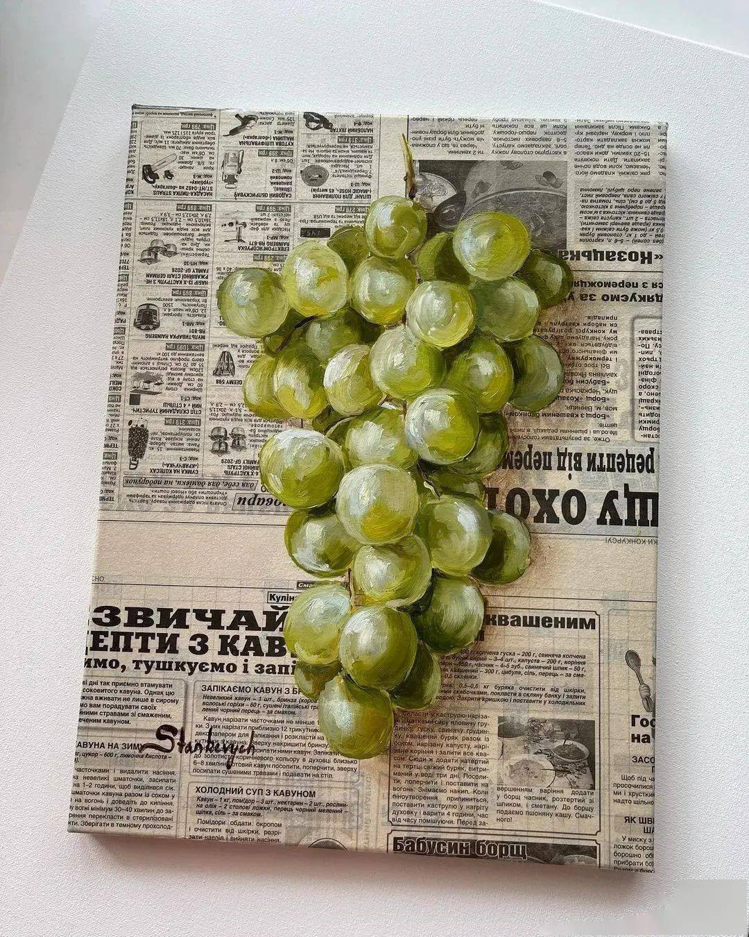 不用猜了,报纸是真的,水果和面包都是画的