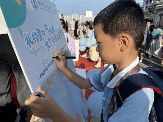 06首都师范大学横琴子期实验小学同学们纷纷在立志墙上签名,写下新